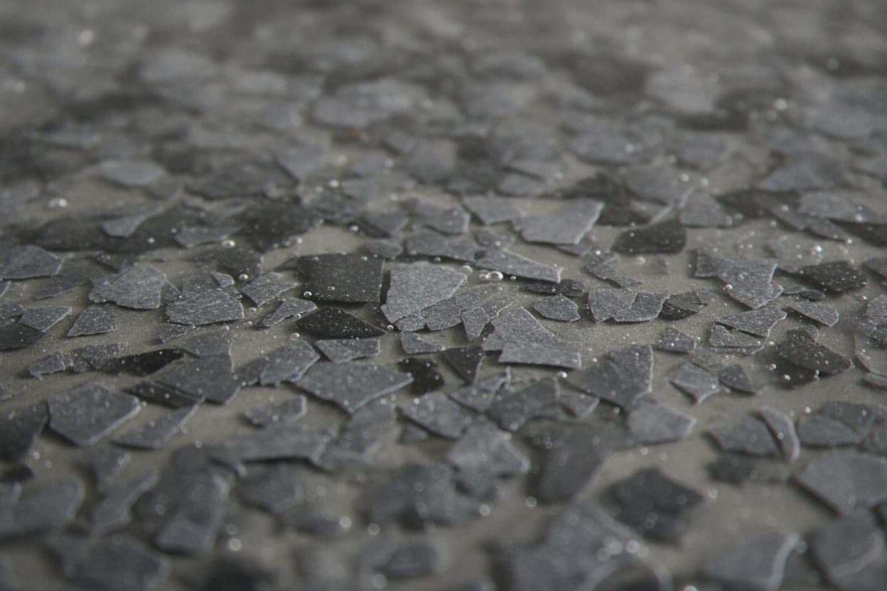 Close-up of polyaspartic film over charcoal flake.